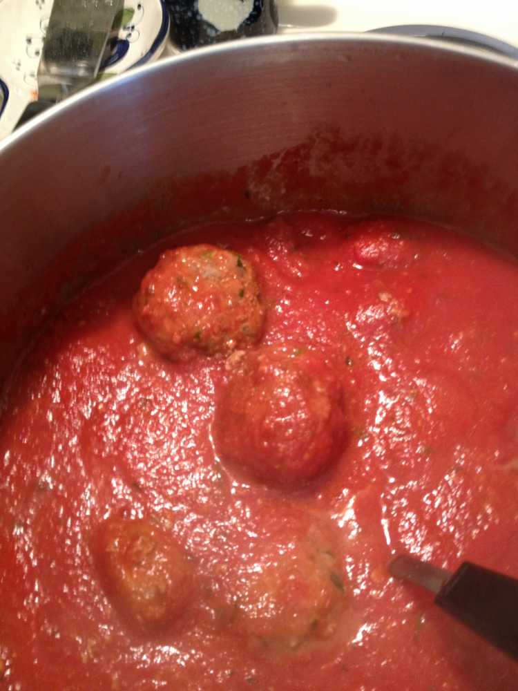 Adding the meatballs a few at a time.